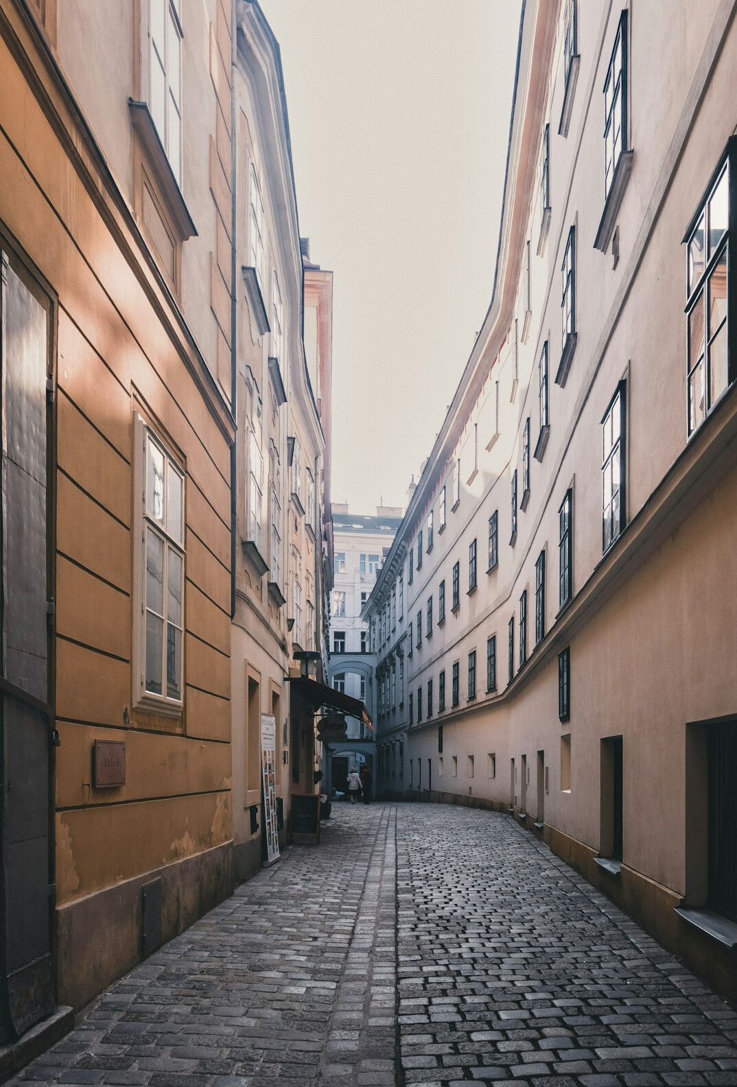Empty city street between old buildings