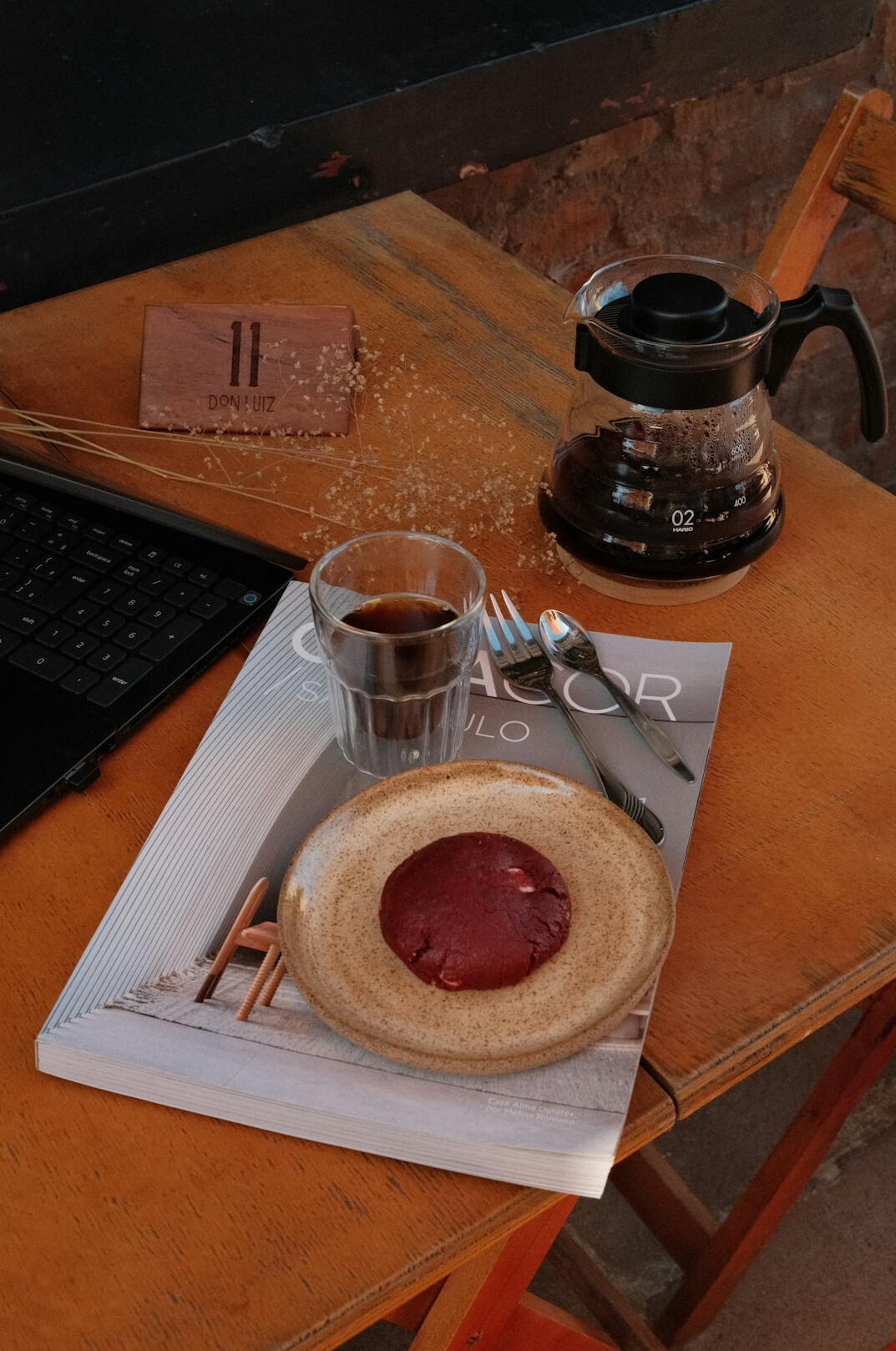 Writing desk with laptop, notebook and coffee